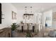 Dining area featuring modern light fixture, comfortable seating, and a view into the living spaces at 6266 Mesa Gln, Bradenton, FL 34203