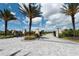 Elegant community entrance with palm trees and paved walkway, creating a welcoming atmosphere at 6266 Mesa Gln, Bradenton, FL 34203