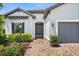 Inviting home exterior with brick paver walkway, detailed front door, and a well-manicured lawn at 6266 Mesa Gln, Bradenton, FL 34203