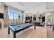 Spacious game room featuring a pool table, large window with seating, and an open kitchen area at 6266 Mesa Gln, Bradenton, FL 34203