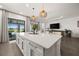 Gourmet kitchen features a large center island, modern lighting, and stainless appliances at 6266 Mesa Gln, Bradenton, FL 34203