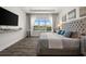 This main bedroom features a large window with a water view, hardwood floors, and a large headboard at 6266 Mesa Gln, Bradenton, FL 34203