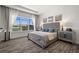 This is a beautiful main bedroom with a view of the water, hardwood floors, and stylish dressers at 6266 Mesa Gln, Bradenton, FL 34203