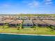 Aerial view of a sparkling pool, lawn, and lake providing a backyard retreat with water views at 6266 Mesa Gln, Bradenton, FL 34203