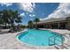 Resort-style pool featuring palm trees, lounge chairs and a covered patio with seating creates an inviting outdoor oasis at 6266 Mesa Gln, Bradenton, FL 34203