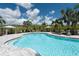 Inviting community pool area with lounge chairs and cabanas surrounded by lush landscaping at 6266 Mesa Gln, Bradenton, FL 34203