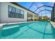 This in-ground pool has a screened-in patio with an outdoor TV and seating area at 6266 Mesa Gln, Bradenton, FL 34203