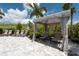 Relaxing poolside lounging with a shaded cabana and several sun loungers, perfect for enjoying sunny days at 6266 Mesa Gln, Bradenton, FL 34203