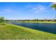 Scenic view of the lake and lush green lawn, offering a serene and picturesque backdrop at 6266 Mesa Gln, Bradenton, FL 34203