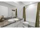 Bathroom with a granite counter, white cabinets, decorative fish and a tub with shower at 6516 Serenity Fall Ln, Sarasota, FL 34240