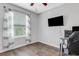 This bedroom has a ceiling fan, modern flooring, and a flat screen television at 6516 Serenity Fall Ln, Sarasota, FL 34240