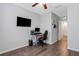 This bedroom has wood floors, neutral gray walls, and a computer desk at 6516 Serenity Fall Ln, Sarasota, FL 34240