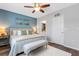 Comfortable bedroom features a king bed, accent wall, and access to the bathroom at 6516 Serenity Fall Ln, Sarasota, FL 34240