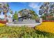 Community sign surrounded by lush greenery, landscaping, and a water feature at 6516 Serenity Fall Ln, Sarasota, FL 34240
