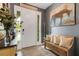 Inviting entryway featuring tile flooring, a decorative bench, and a horse painting, creating a warm welcome at 6516 Serenity Fall Ln, Sarasota, FL 34240