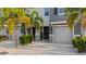 Inviting townhome entrance featuring a stylish door, manicured plants, and pristine driveway at 6516 Serenity Fall Ln, Sarasota, FL 34240