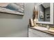 Elegant half bathroom featuring granite countertops, stylish decor, and a decorative mirror at 6516 Serenity Fall Ln, Sarasota, FL 34240