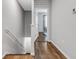 Bright hallway showcasing wood flooring and leading to a bedroom with natural light at 6516 Serenity Fall Ln, Sarasota, FL 34240