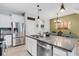 Open kitchen features stainless steel appliances, a large island, and seamless access to the dining area at 6516 Serenity Fall Ln, Sarasota, FL 34240