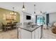 Spacious kitchen island open to dining area and Gathering room creating seamless living space at 6516 Serenity Fall Ln, Sarasota, FL 34240