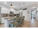 Bright kitchen with stainless steel appliances, granite countertops, white cabinetry, and a center island at 6516 Serenity Fall Ln, Sarasota, FL 34240