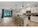 Kitchen and living area showcasing an open layout, stainless steel appliances, and seamless flow to the patio at 6516 Serenity Fall Ln, Sarasota, FL 34240