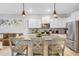 Gourmet kitchen with breakfast bar, stainless steel appliances, granite counters, and open concept design at 6516 Serenity Fall Ln, Sarasota, FL 34240