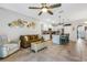 Open concept living room with kitchen and dining, modern decor and lots of sunlight at 6516 Serenity Fall Ln, Sarasota, FL 34240