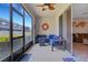 Enclosed patio featuring ceiling fan, coastal decor and outdoor seating at 6516 Serenity Fall Ln, Sarasota, FL 34240
