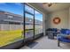 Enclosed patio with sliding door to the back yard, outdoor furniture and Coastal decor at 6516 Serenity Fall Ln, Sarasota, FL 34240