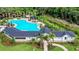 Aerial view of a pool area with mature landscaping and a covered structure for outdoor relaxation at 6516 Serenity Fall Ln, Sarasota, FL 34240