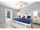 Coastal bedroom featuring a white bed frame, blue bedding, and a patio door at 7209 35Th E St, Sarasota, FL 34243