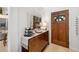 Inviting entryway with a decorative mirror, wine rack, and a warm wooden front door at 7209 35Th E St, Sarasota, FL 34243