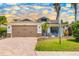 Charming home featuring a brick driveway, two-car garage, and well-manicured lawn with mature landscaping at 7209 35Th E St, Sarasota, FL 34243
