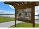 Wooden information board with various event posters overlooking the water on a sunny day at Nathan Benderson Park at 7209 35Th E St, Sarasota, FL 34243