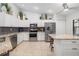 Bright kitchen featuring white cabinets, stainless steel appliances, granite countertops, and a stylish island at 7209 35Th E St, Sarasota, FL 34243