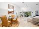 Living and dining room area with bright furniture and sliding glass doors to the lanai at 7209 35Th E St, Sarasota, FL 34243