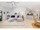 Spacious living room with a comfortable sofa, coastal-themed decor, and an open layout to the kitchen at 7209 35Th E St, Sarasota, FL 34243