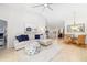 Open-concept living room with neutral decor, tile flooring, and seamless flow to the dining and kitchen areas at 7209 35Th E St, Sarasota, FL 34243