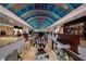 A bustling view of The Mall at UTC's bright interior, with high-end shops beneath an illuminated, arched ceiling at 7209 35Th E St, Sarasota, FL 34243