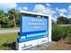 Blue and white sign for Nathan Benderson Park set against a backdrop of lush greenery on a bright day at 7209 35Th E St, Sarasota, FL 34243