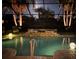 Inviting screened-in pool with a jacuzzi and palm trees, creating a serene and luxurious backyard retreat at 7209 35Th E St, Sarasota, FL 34243