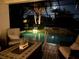 Relaxing screened-in patio with comfortable seating overlooking a pool and jacuzzi, perfect for outdoor lounging at 7209 35Th E St, Sarasota, FL 34243