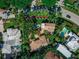 An aerial view of the neighborhood, showcasing mature trees, nearby homes, and a glimpse of the surrounding streets at 76 S Washington Dr, Sarasota, FL 34236