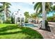 Expansive backyard with a pool, a fountain, brick patio, and outdoor seating, great for entertaining at 76 S Washington Dr, Sarasota, FL 34236