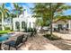 A backyard patio with outdoor dining, lounge chairs, a grill, and a bar by the beautiful pool at 76 S Washington Dr, Sarasota, FL 34236