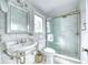 Bathroom featuring white marble, pedestal sink, and glass-enclosed shower at 76 S Washington Dr, Sarasota, FL 34236