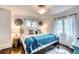 Stylish bedroom with a king bed, decorative pillows, and hardwood floors at 76 S Washington Dr, Sarasota, FL 34236