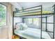 bedroom featuring a modern black metal bunk bed with blue and green striped bedding, and natural light at 76 S Washington Dr, Sarasota, FL 34236