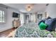 Comfortable bedroom with a ceiling fan, dresser and access to a patio at 76 S Washington Dr, Sarasota, FL 34236
